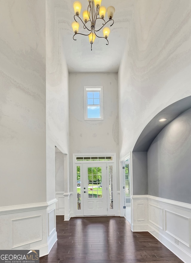 1231 Fawndale Dr NW, Kennesaw, GA 30152 - foyer featuring a chandelier, wood finished floors, a decorative wall, a wainscoted wall, and a towering ceiling