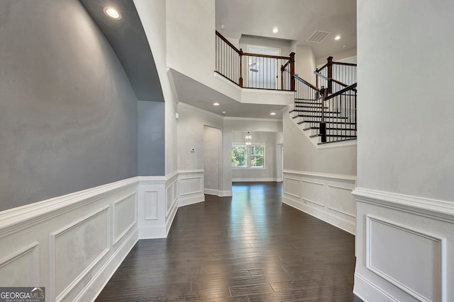 1231 Fawndale Dr NW, Kennesaw, GA 30152 - stairs with a decorative wall, wood finished floors, wainscoting, a towering ceiling, and recessed lighting