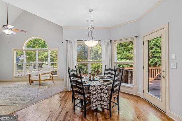 1500 Royce Dr, Locust Grove, GA 30248 - dining room with a ceiling fan, light wood-type flooring, baseboards, crown molding, and a towering ceiling