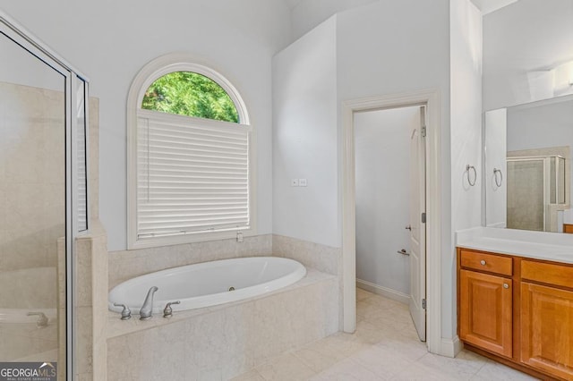 1500 Royce Dr, Locust Grove, GA 30248 - full bath with vanity, a stall shower, a garden tub, and tile patterned floors