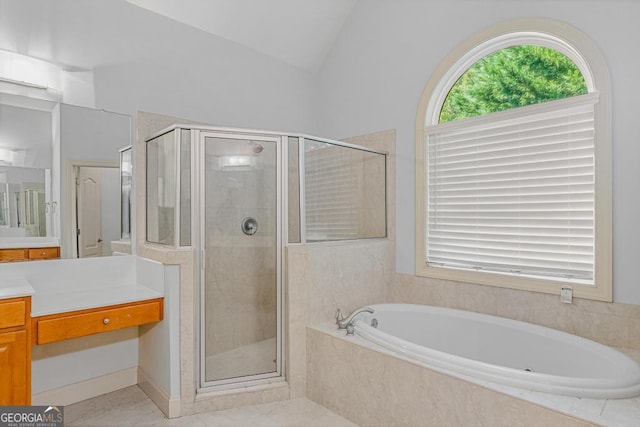 1500 Royce Dr, Locust Grove, GA 30248 - full bathroom with vanity, a bath, a stall shower, vaulted ceiling, and tile patterned floors