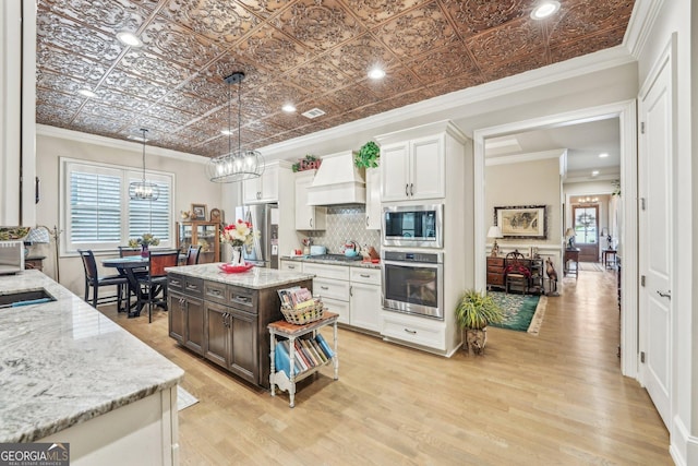 332 Rosshandler Rd, Suwanee, GA 30024 - kitchen with appliances with stainless steel finishes, custom exhaust hood, light wood-type flooring, tasteful backsplash, and a chandelier
