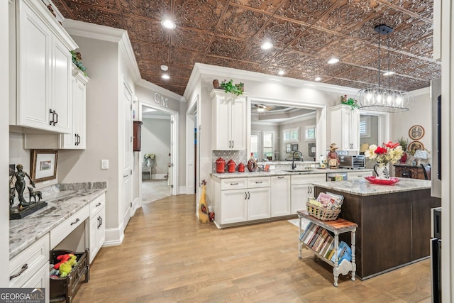 332 Rosshandler Rd, Suwanee, GA 30024 - kitchen featuring crown molding, a sink, white cabinetry, an ornate ceiling, and light wood-type flooring