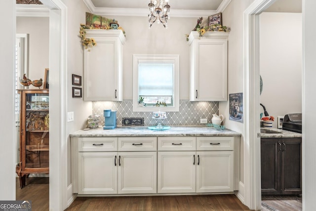 332 Rosshandler Rd, Suwanee, GA 30024 - kitchen with backsplash, dark wood finished floors, white cabinetry, ornamental molding, and light stone counters