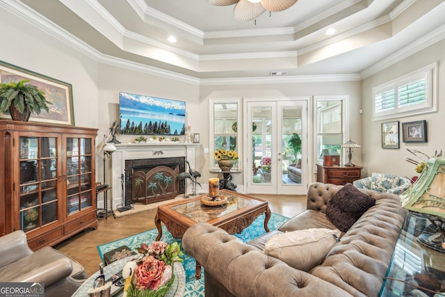 332 Rosshandler Rd, Suwanee, GA 30024 - living room featuring french doors, a tray ceiling, ornamental molding, a fireplace, and ceiling fan