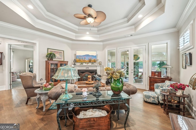 332 Rosshandler Rd, Suwanee, GA 30024 - living area with wood finished floors, a raised ceiling, a fireplace, crown molding, and a ceiling fan