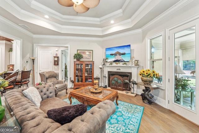 332 Rosshandler Rd, Suwanee, GA 30024 - living room with a raised ceiling, wood finished floors, ceiling fan, a fireplace, and crown molding