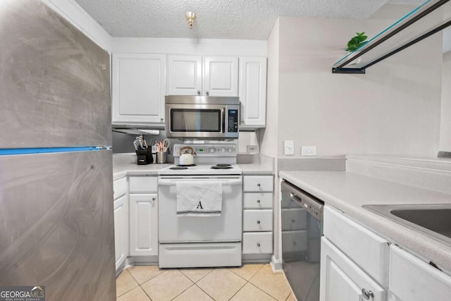 375 Ralph Mcgill Blvd NE Unit 707, Atlanta, GA 30312 - kitchen with stainless steel appliances, white cabinets, light countertops, light tile patterned floors, and a textured ceiling