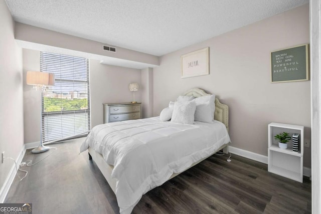 375 Ralph Mcgill Blvd NE Unit 707, Atlanta, GA 30312 - bedroom featuring baseboards, a textured ceiling, and wood finished floors