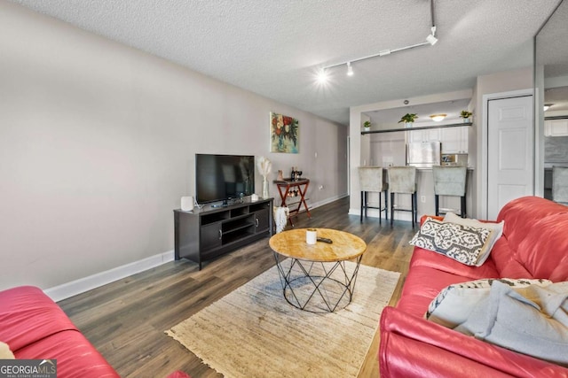 375 Ralph Mcgill Blvd NE Unit 707, Atlanta, GA 30312 - living room with baseboards, wood finished floors, a textured ceiling, and track lighting