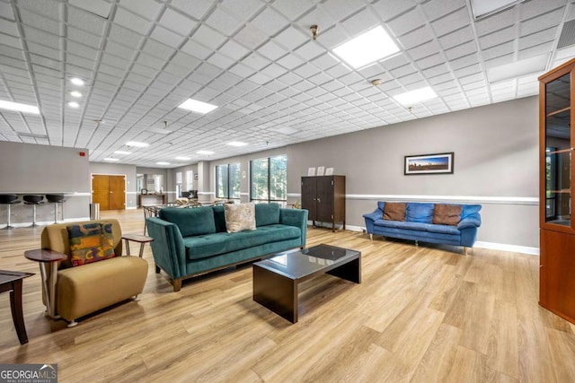 375 Ralph Mcgill Blvd NE Unit 707, Atlanta, GA 30312 - living area featuring light wood finished floors, baseboards, and a drop ceiling