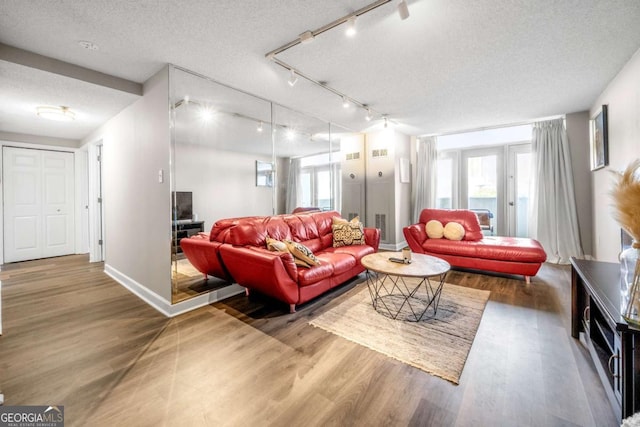 375 Ralph Mcgill Blvd NE Unit 707, Atlanta, GA 30312 - living room with a textured ceiling, track lighting, wood finished floors, and baseboards