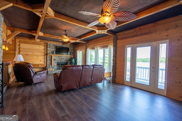 230 Kelly Dr, Hamilton, GA 31811 - living area featuring wood walls, a ceiling fan, a fireplace, dark wood-style floors, and wood ceiling with exposed beams