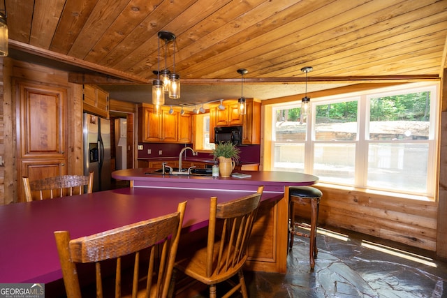 230 Kelly Dr, Hamilton, GA 31811 - kitchen with black microwave, stainless steel fridge with ice dispenser, wooden ceiling, a sink, and brown cabinets