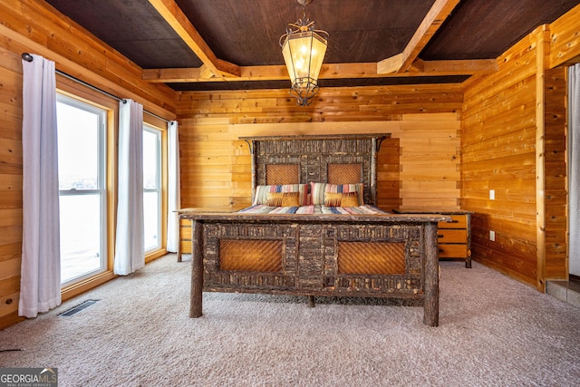 230 Kelly Dr, Hamilton, GA 31811 - bedroom with wood walls, wooden ceiling with exposed beams, and carpet flooring