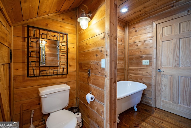230 Kelly Dr, Hamilton, GA 31811 - full bathroom featuring wooden walls, a soaking tub, wood ceiling, toilet, and wood finished floors