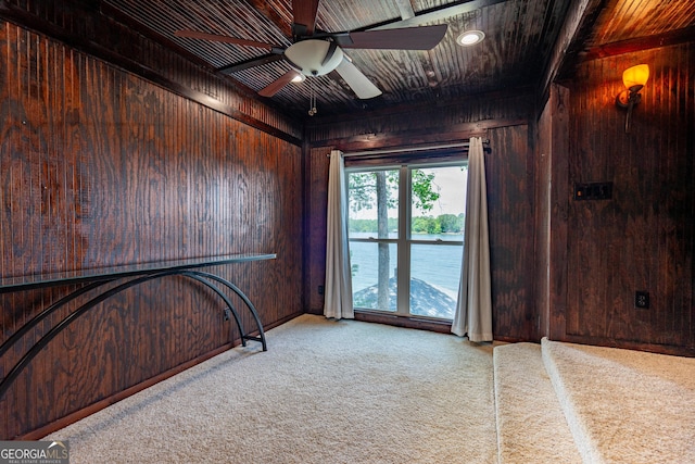 230 Kelly Dr, Hamilton, GA 31811 - empty room with wooden walls, carpet flooring, ceiling fan, and baseboards