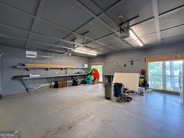 230 Kelly Dr, Hamilton, GA 31811 - garage with a garage door opener and freestanding refrigerator