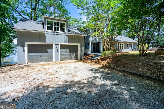 230 Kelly Dr, Hamilton, GA 31811 - mid-century home with board and batten siding, driveway, and roof with shingles