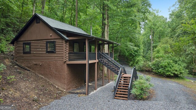 853 Bates Rd, Ellijay, GA 30540 - view of property exterior featuring log siding, stairway, and a wooded view