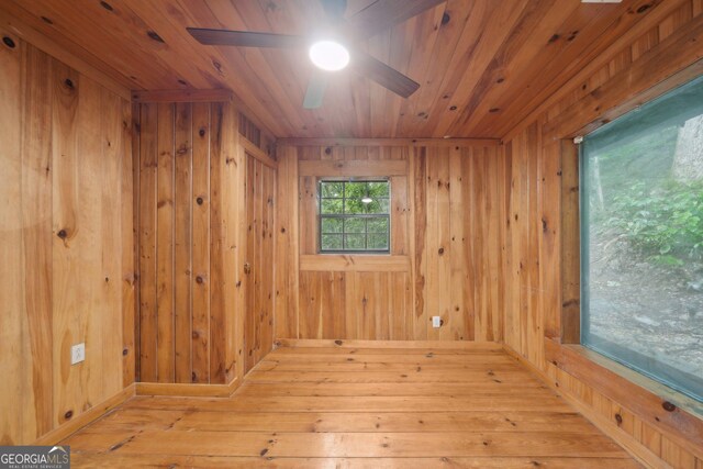 853 Bates Rd, Ellijay, GA 30540 - empty room with a ceiling fan, wood walls, wood ceiling, and hardwood / wood-style flooring