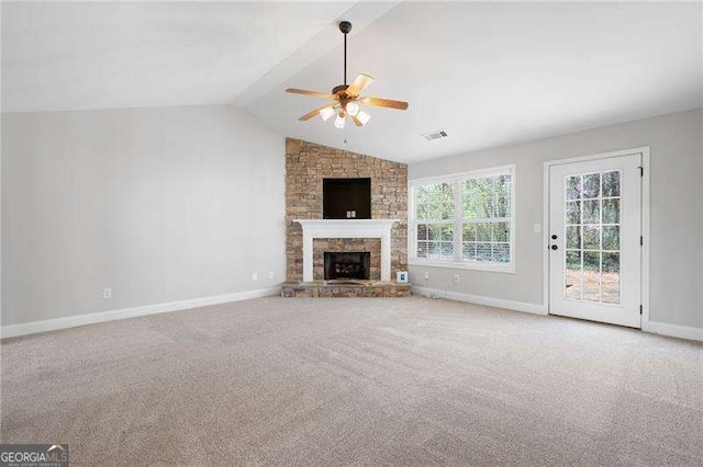 85 Stiles Dr, Dallas, GA 30132 - unfurnished living room with ceiling fan, lofted ceiling, carpet floors, and a stone fireplace