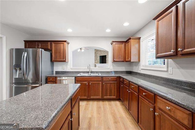 85 Stiles Dr, Dallas, GA 30132 - kitchen with stainless steel appliances, light wood finished floors, dark stone countertops, brown cabinetry, and recessed lighting