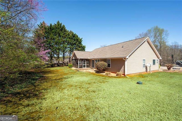 85 Stiles Dr, Dallas, GA 30132 - rear view of house featuring a sunroom and a lawn