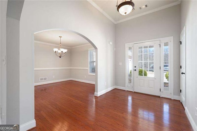 85 Stiles Dr, Dallas, GA 30132 - foyer entrance with a chandelier, healthy amount of natural light, arched walkways, wood finished floors, and crown molding