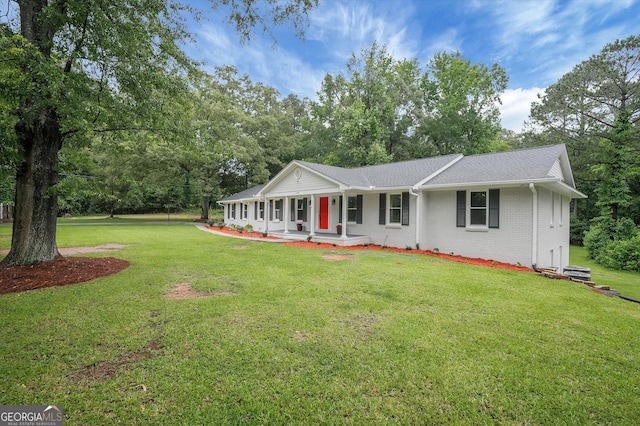 3290 Ebenezer Rd SE, Conyers, GA 30094 - view of front of property with covered porch, brick siding, a front lawn, and a shingled roof