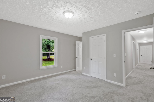 3290 Ebenezer Rd SE, Conyers, GA 30094 - unfurnished bedroom featuring carpet, baseboards, and a textured ceiling