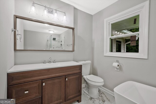 3290 Ebenezer Rd SE, Conyers, GA 30094 - bathroom featuring marble finish flooring, a freestanding tub, vanity, baseboards, and toilet