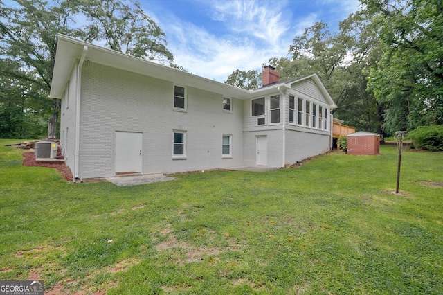 3290 Ebenezer Rd SE, Conyers, GA 30094 - rear view of house featuring a chimney, a lawn, brick siding, and central air condition unit