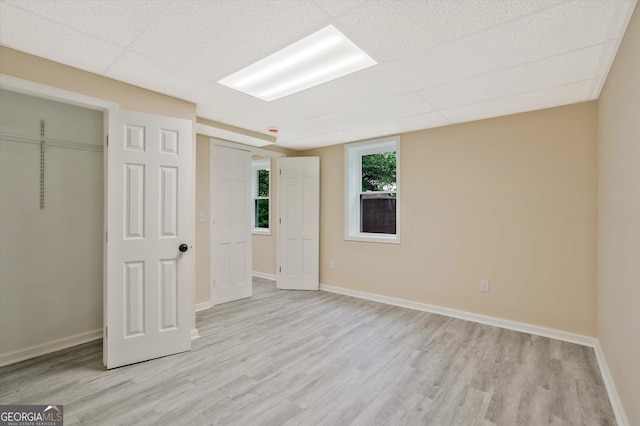 3290 Ebenezer Rd SE, Conyers, GA 30094 - unfurnished bedroom with wood finished floors, baseboards, a paneled ceiling, and a closet