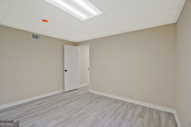 3290 Ebenezer Rd SE, Conyers, GA 30094 - empty room with a paneled ceiling, light wood finished floors, and baseboards