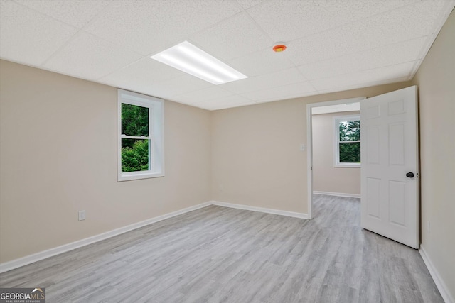 3290 Ebenezer Rd SE, Conyers, GA 30094 - spare room featuring light wood-style floors, a drop ceiling, and baseboards