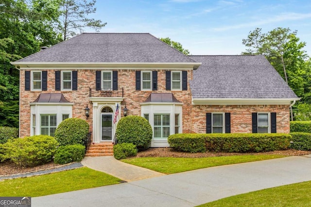 360 Spindle Ct, Sandy Springs, GA 30350 - colonial inspired home featuring roof with shingles, brick siding, and a front lawn