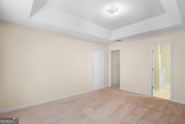 3599 Salem Glen Rd, Lithonia, GA 30038 - unfurnished bedroom featuring a tray ceiling, carpet, baseboards, and ensuite bath
