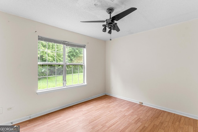 3599 Salem Glen Rd, Lithonia, GA 30038 - unfurnished room featuring light wood-type flooring, a ceiling fan, baseboards, and a textured ceiling