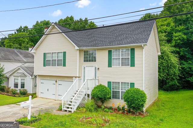 3599 Salem Glen Rd, Lithonia, GA 30038 - raised ranch with driveway, an attached garage, a shingled roof, and a front yard