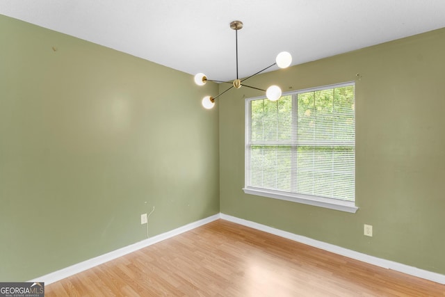 3599 Salem Glen Rd, Lithonia, GA 30038 - unfurnished room with a chandelier, wood finished floors, and baseboards