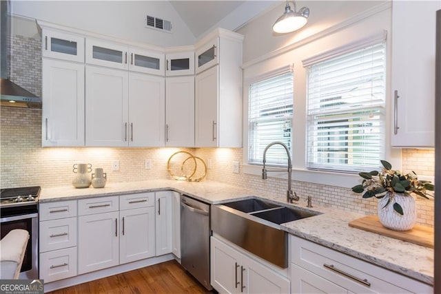 151 Savannah St SE, Atlanta, GA 30316 - kitchen featuring appliances with stainless steel finishes, a sink, vaulted ceiling, white cabinetry, and tasteful backsplash