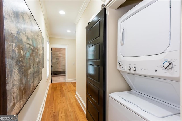 151 Savannah St SE, Atlanta, GA 30316 - washroom featuring stacked washing machine and dryer, light wood-style floors, baseboards, crown molding, and recessed lighting