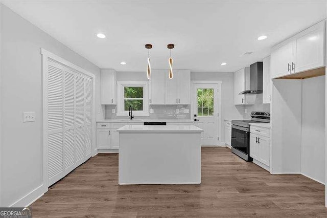 2326 Brackett St SW, Marietta, GA 30060 - kitchen with electric range, wall chimney range hood, healthy amount of natural light, white cabinets, and recessed lighting