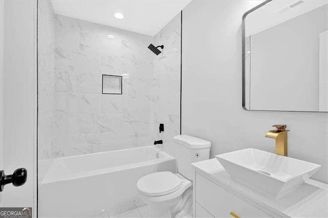 2326 Brackett St SW, Marietta, GA 30060 - full bath featuring toilet, shower / tub combination, vanity, marble look tiles, and recessed lighting