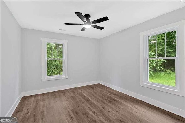 2326 Brackett St SW, Marietta, GA 30060 - unfurnished room featuring baseboards, dark wood-style flooring, and a ceiling fan