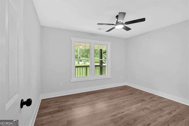 2326 Brackett St SW, Marietta, GA 30060 - spare room with baseboards, dark wood-style flooring, and a ceiling fan