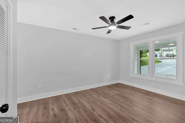2326 Brackett St SW, Marietta, GA 30060 - spare room featuring wood finished floors, baseboards, and ceiling fan