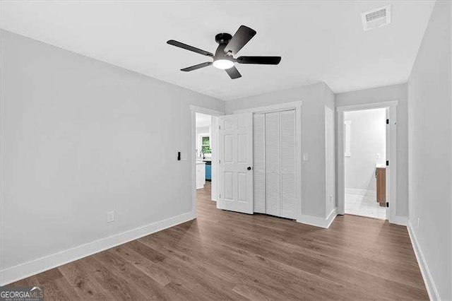 2326 Brackett St SW, Marietta, GA 30060 - unfurnished bedroom featuring baseboards, dark wood finished floors, a closet, and ceiling fan