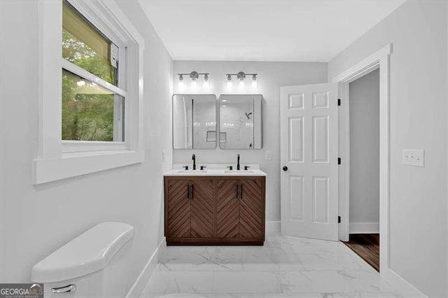 2326 Brackett St SW, Marietta, GA 30060 - bathroom with marble look tile flooring, baseboards, double vanity, toilet, and a shower